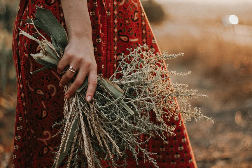 Woman carrying harvested plants